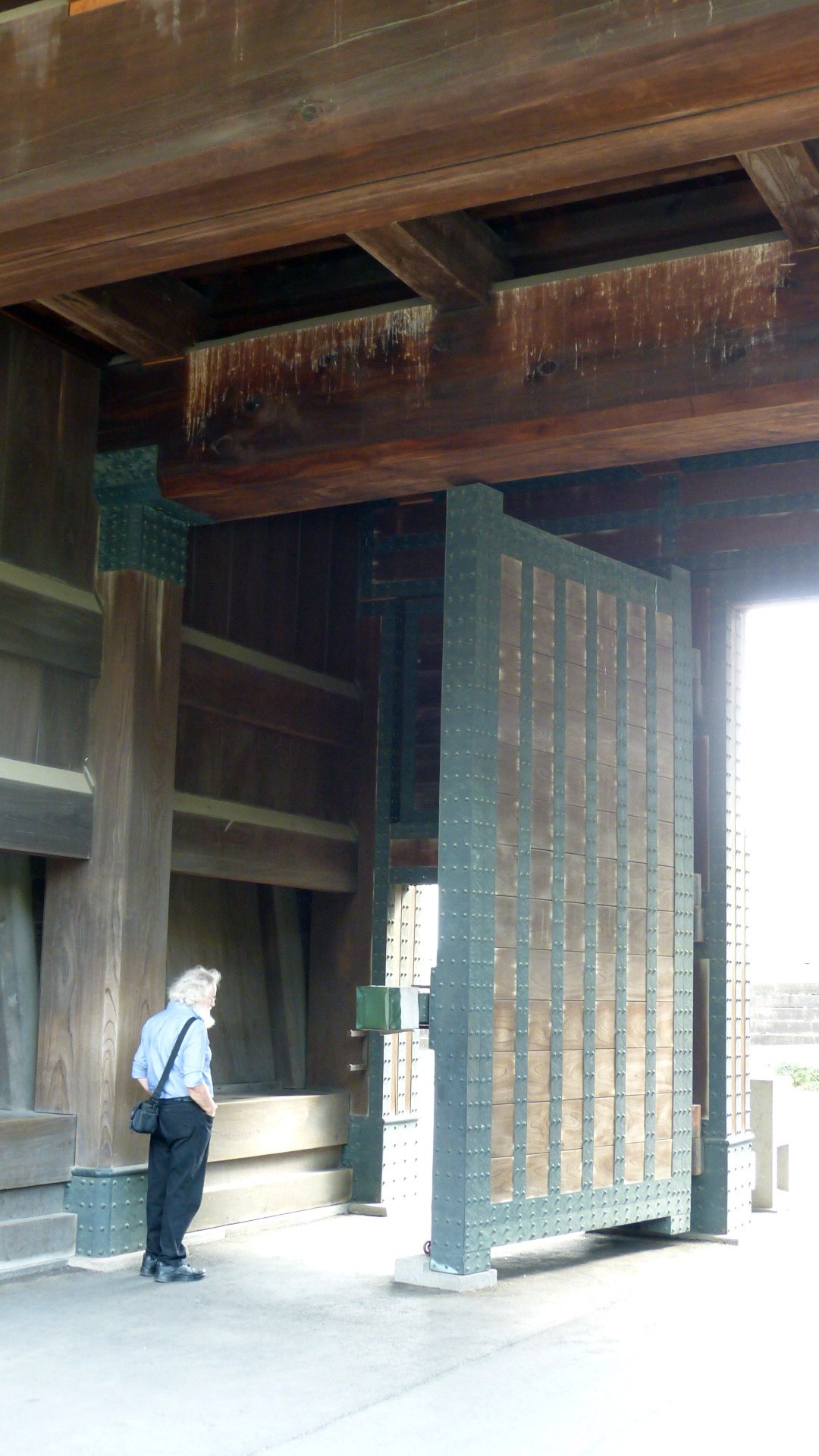 chris standing in the wood and metal entrance gateway